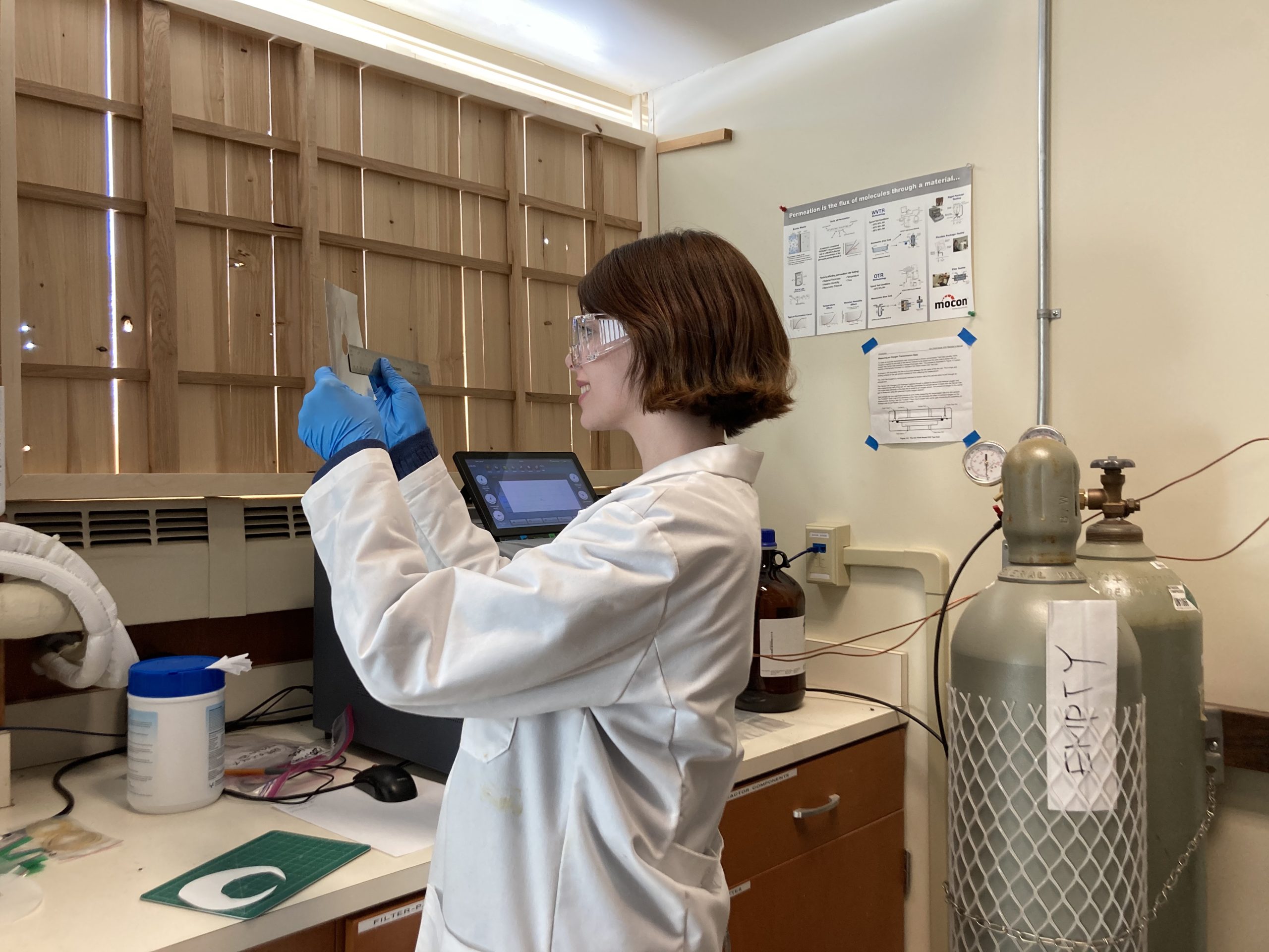 Student holds up biomaterial.